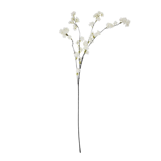 Artificial flower branch with white flowers on a white background