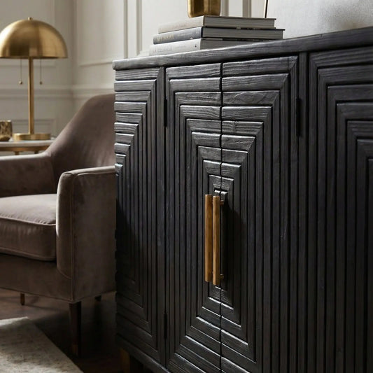 Dark wooden sideboard with gold handles in a living room setting