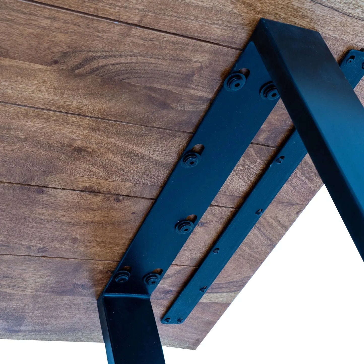 Black metal brackets on a wooden surface