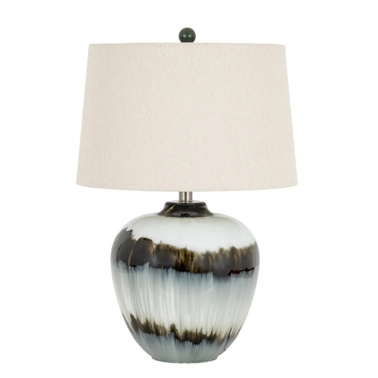 Table lamp with a ceramic base and beige lampshade on a white background