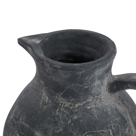 Black ceramic pitcher on a white background
