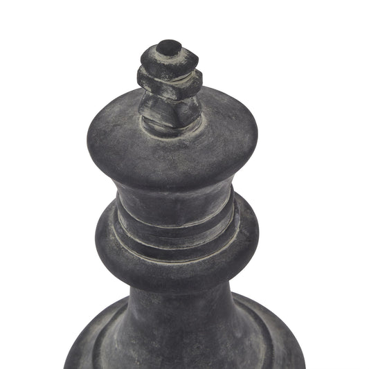 Black chess piece, likely a king, on a white background