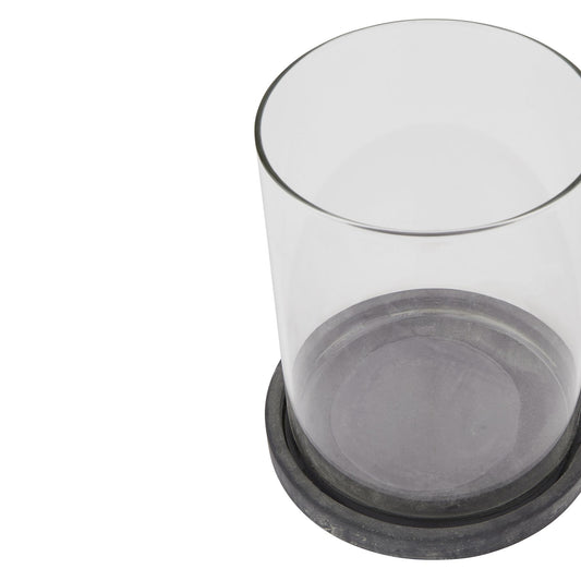 Clear glass container with black base on a white background