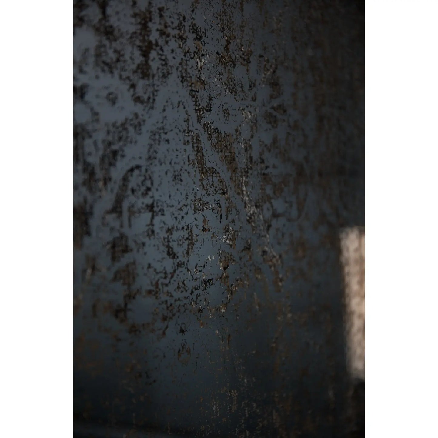 Close-up of a textured metal surface with rust and wear.
