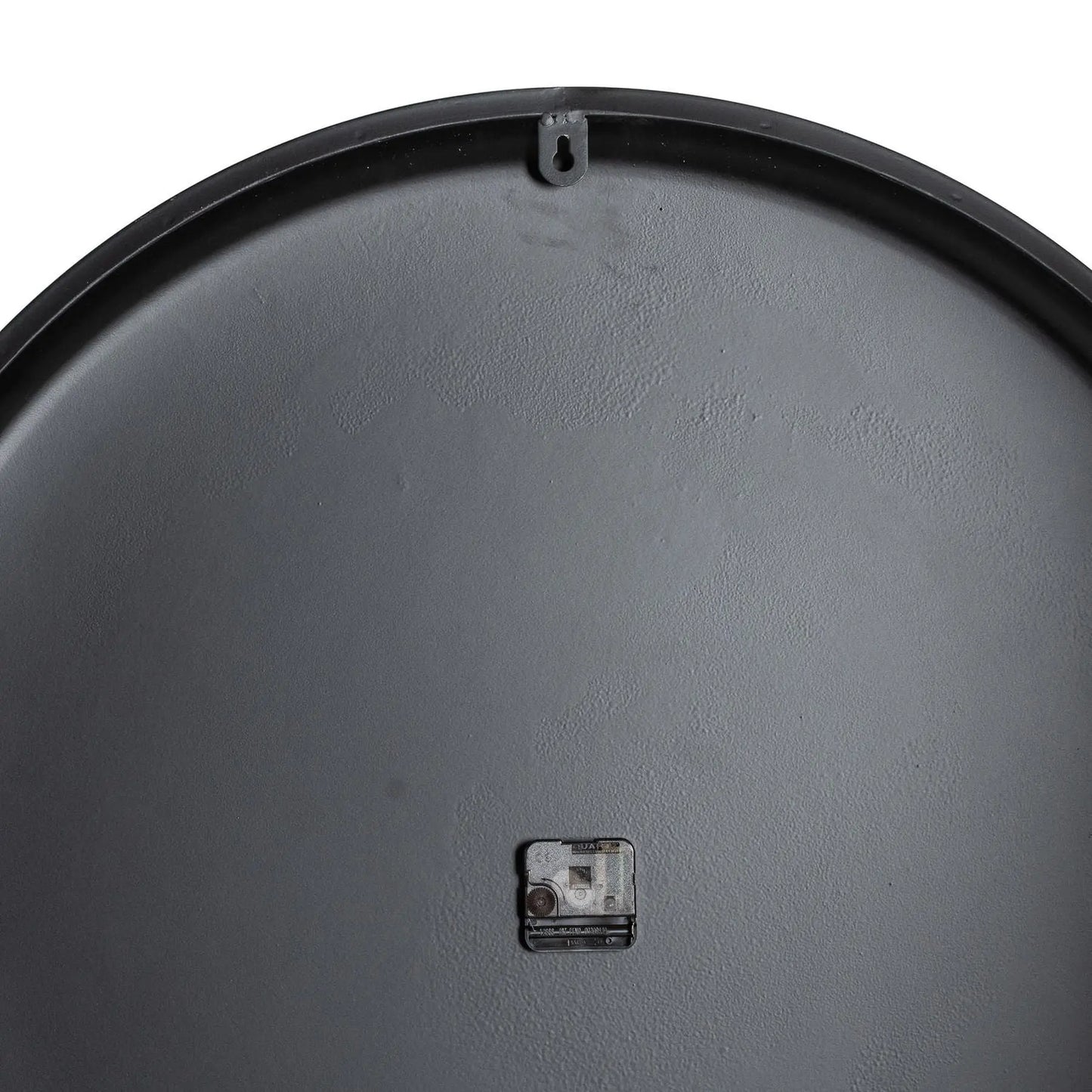 Close-up of a gray metal surface with a small rectangular component on a white background