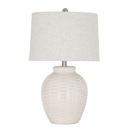 Table lamp with textured white base and light gray shade on a white background