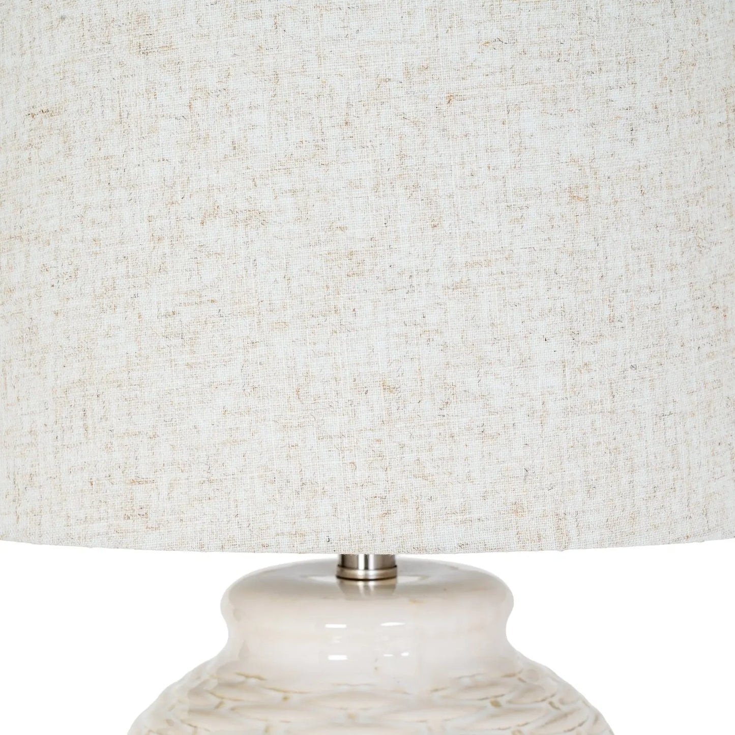 Close-up of a textured lampshade with a marble-like base.