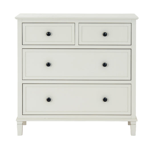 White dresser with four drawers and black knobs on a white background