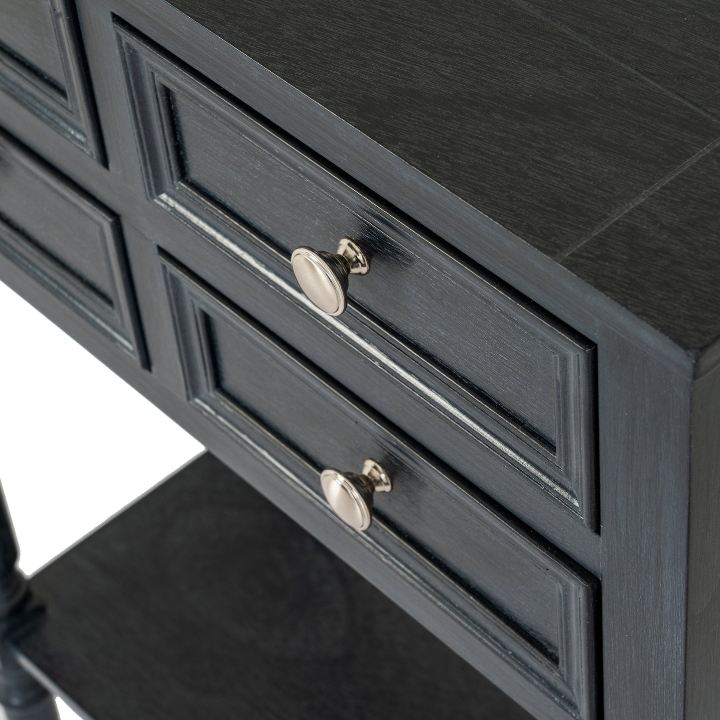 Close-up of a dark gray dresser with silver knobs on a white background