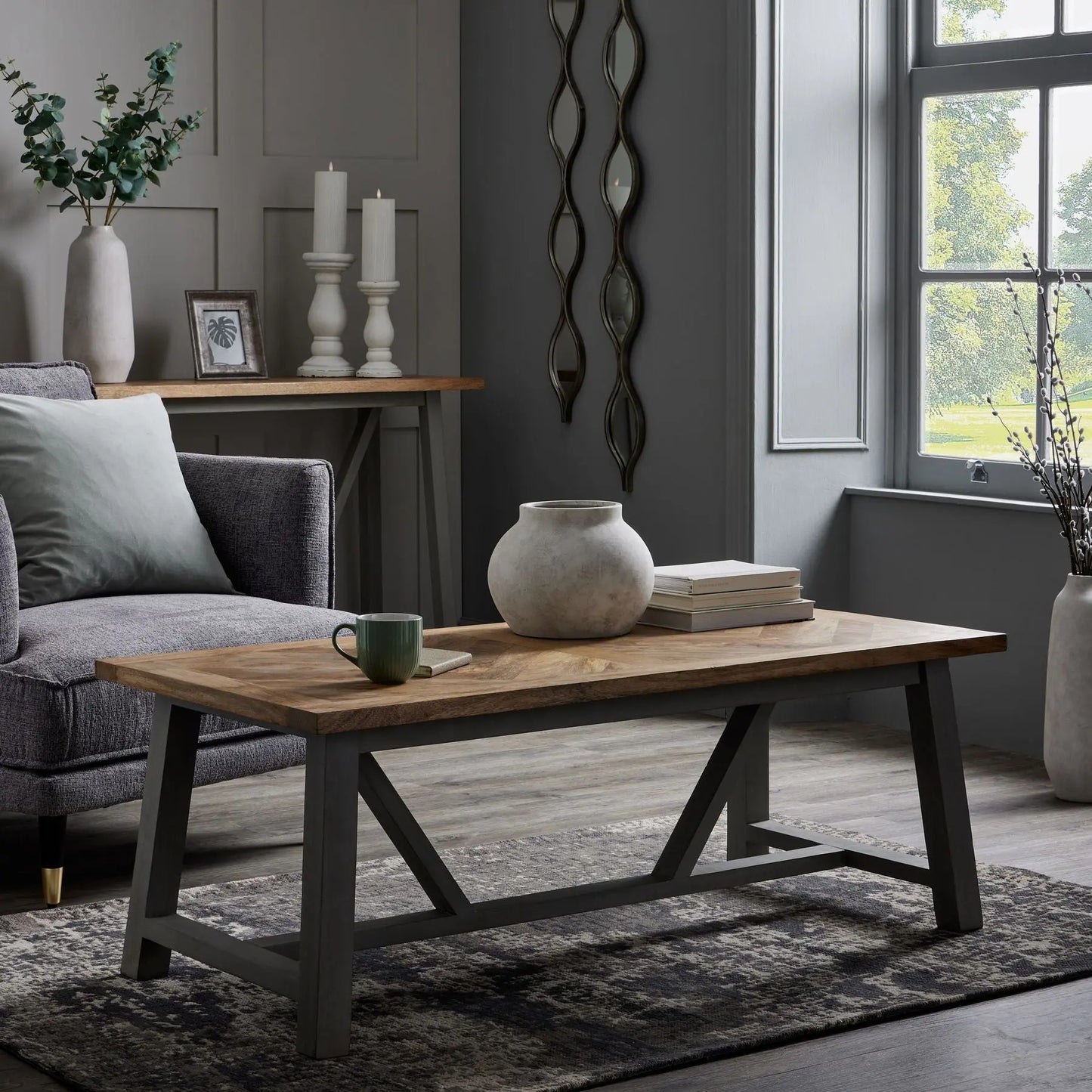Living room with a wooden coffee table, gray sofa, and decorative elements.