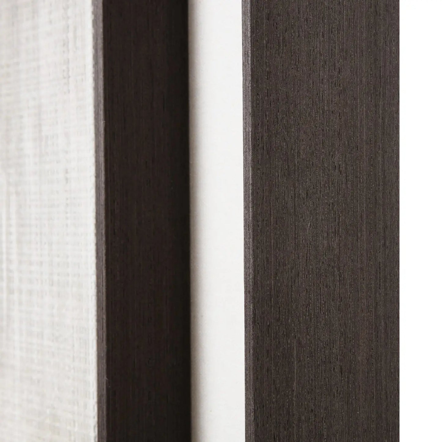 Close-up of fabric swatches in white, dark brown, and gray.