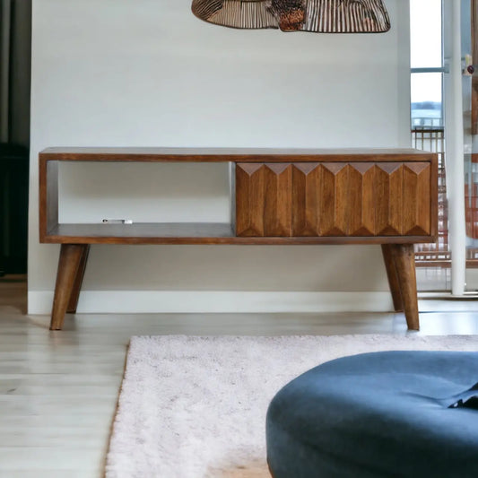 Wooden TV stand in a room with a rug and chair