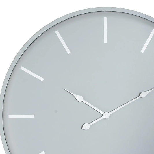 Silver wall clock with white hands on a white background