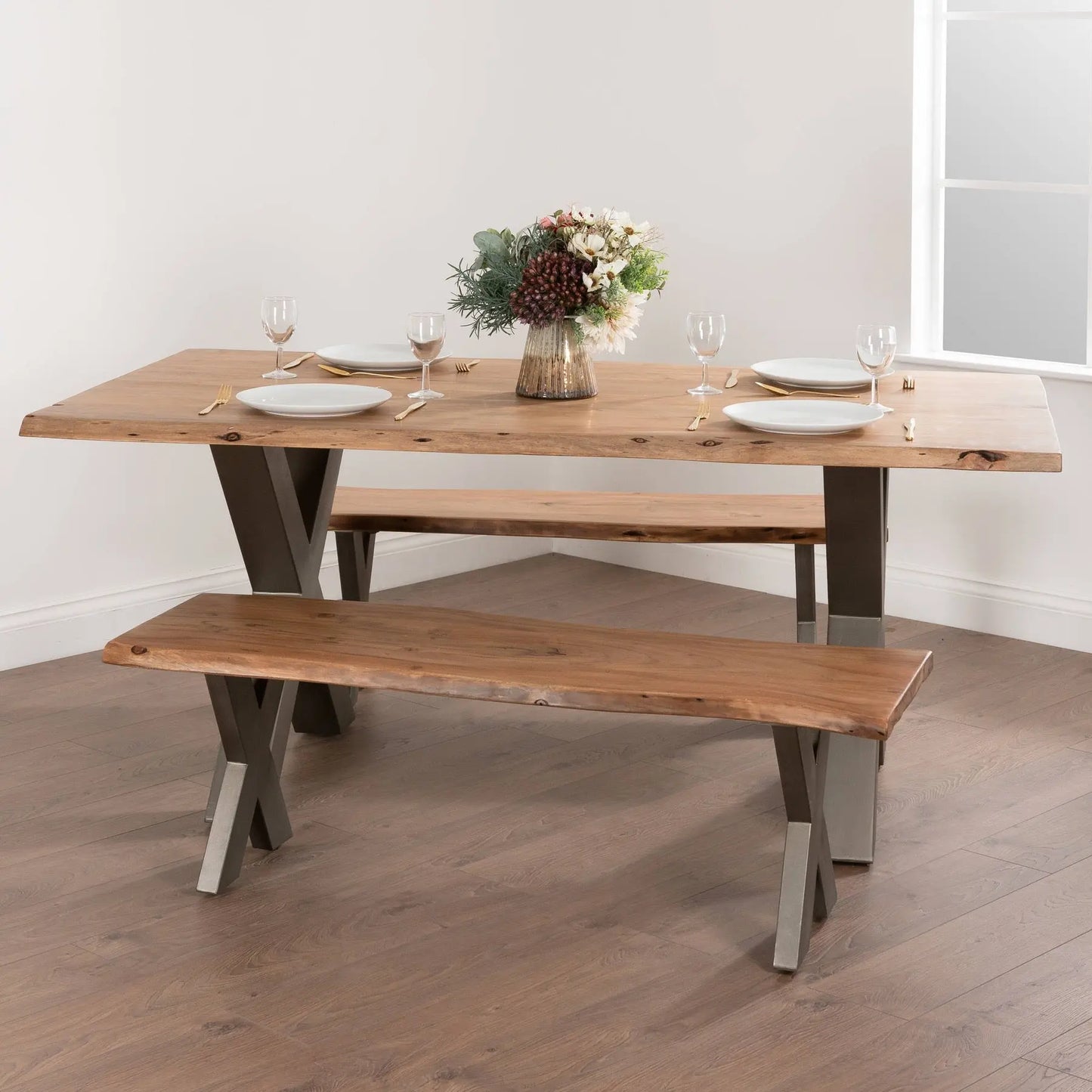 Wooden dining table with bench in a room with a window