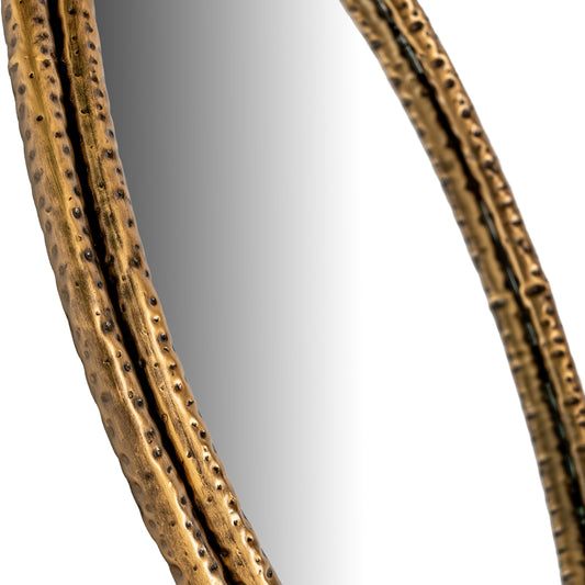 Close-up of a decorative mirror with a textured gold frame on a white background