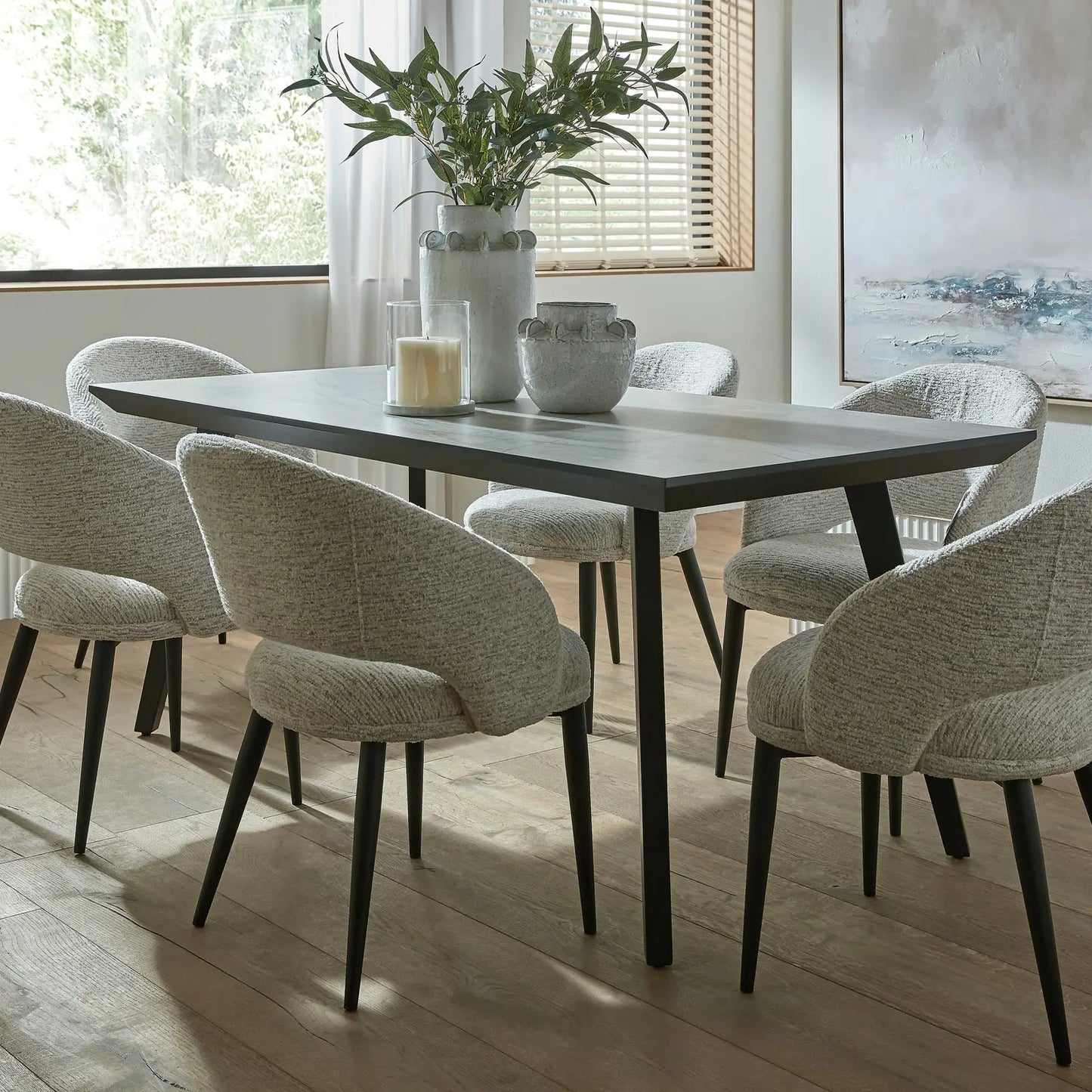 Dining room with a table and chairs in a well-lit room.