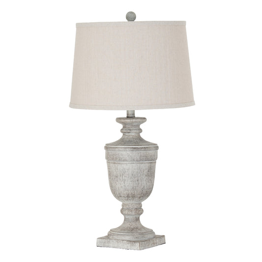 Table lamp with a textured gray base and a white lampshade on a white background