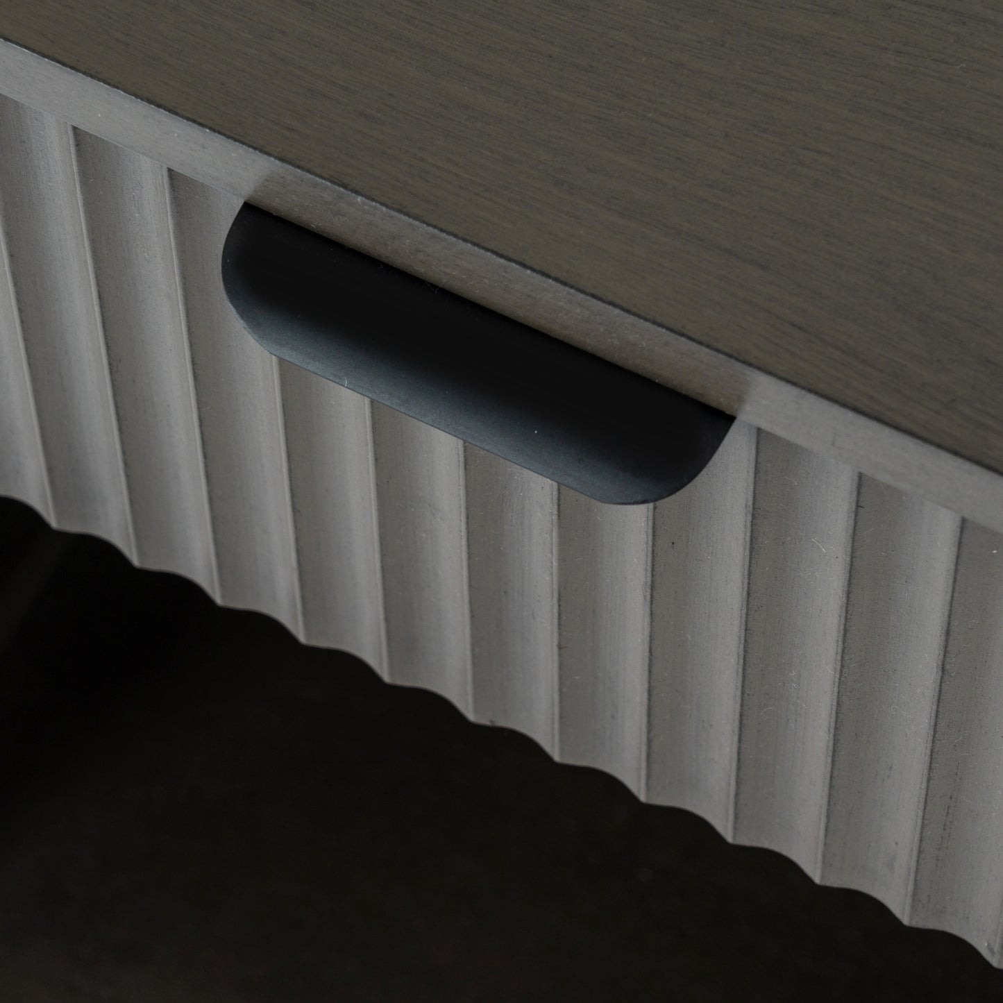 Close-up of a textured surface with a handle and ribbed pattern.