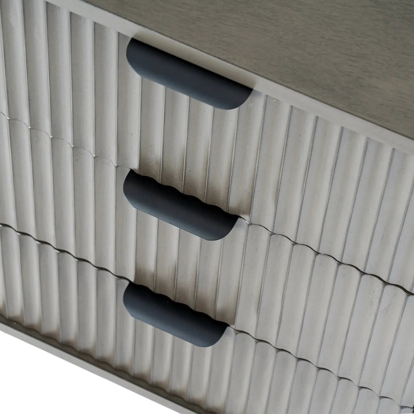 Close-up of a textured surface with three black handles