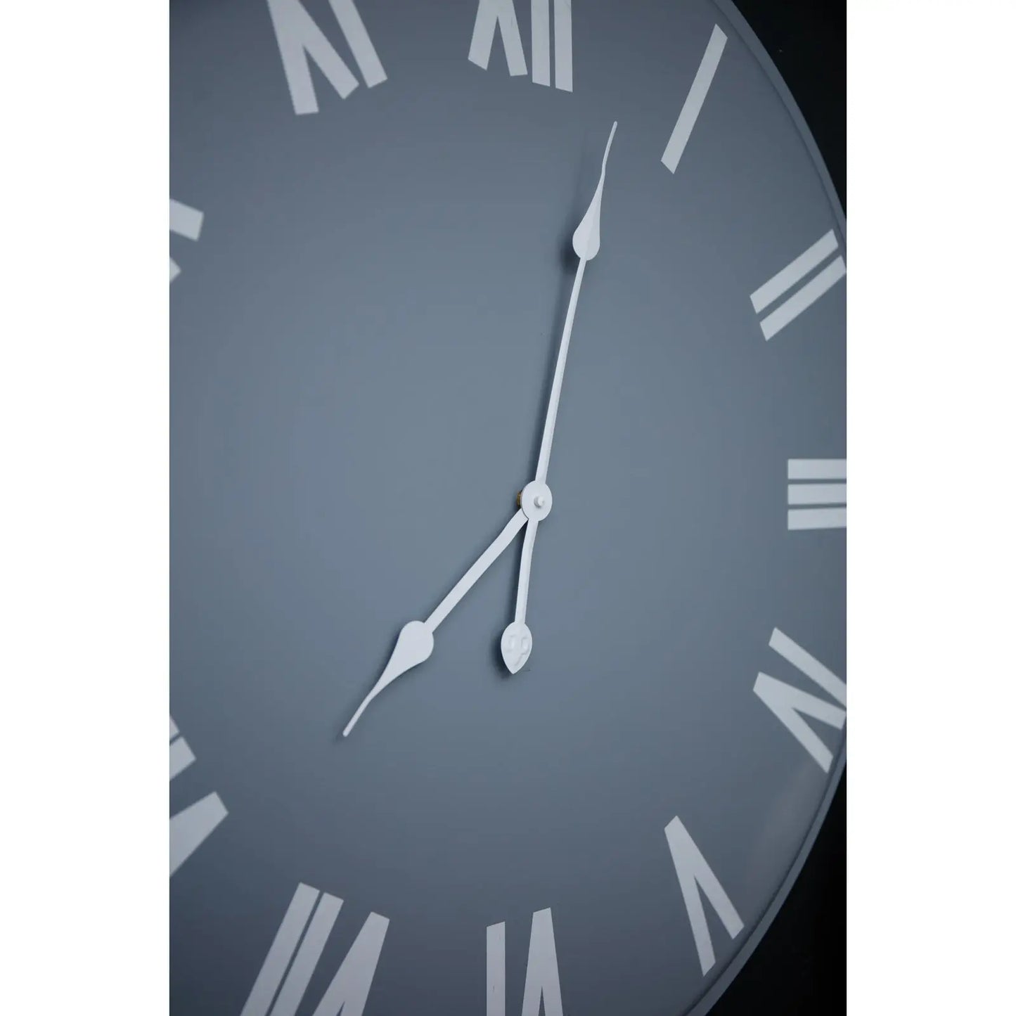 Close-up of a clock face with Roman numerals on a dark background