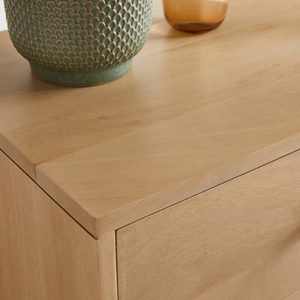 Wooden sideboard with a ceramic vase on top