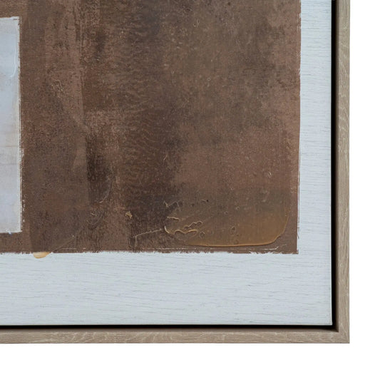 Close-up of a framed artwork with a signature on a brown mat.