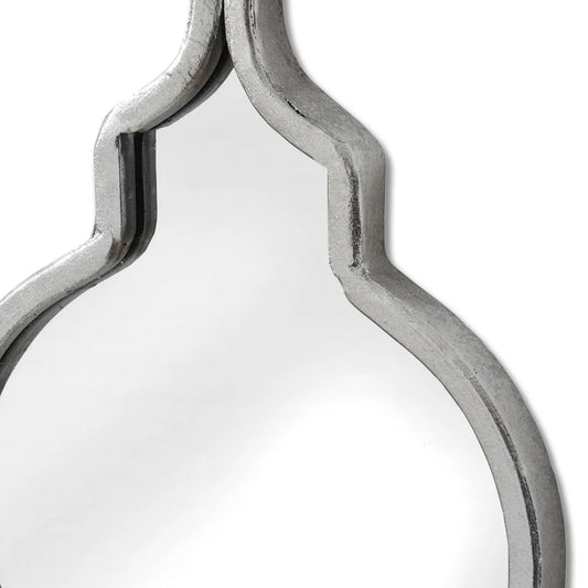 Decorative mirror with a silver frame on a white background
