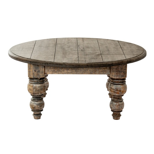 Round wooden table with rustic legs on a white background