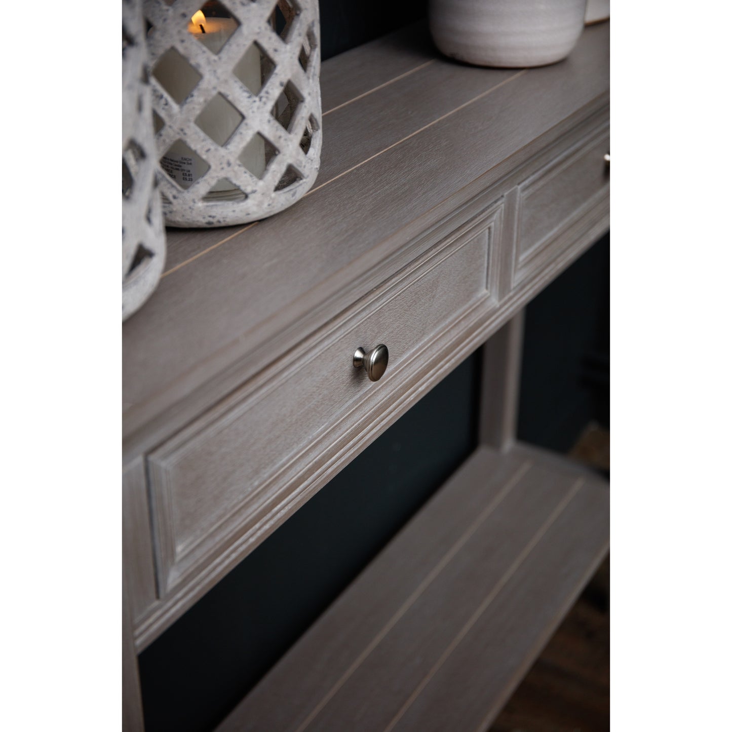 Wooden drawer with a decorative candle holder on top