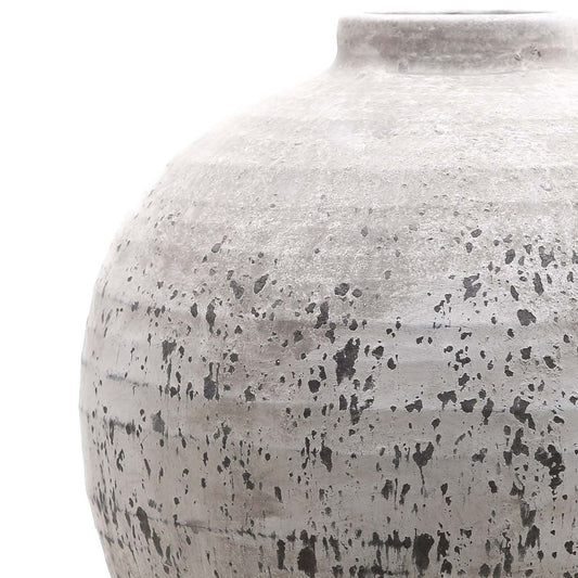 Close-up of a textured ceramic jar on a white background