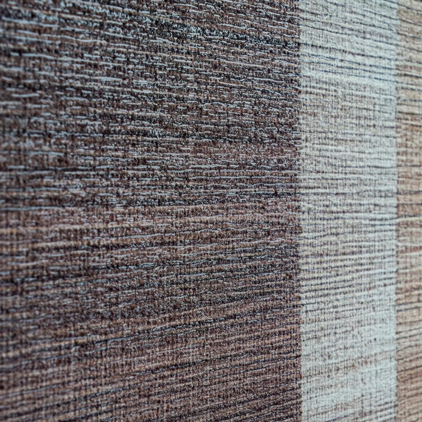 Close-up of a textured fabric with brown and beige colors