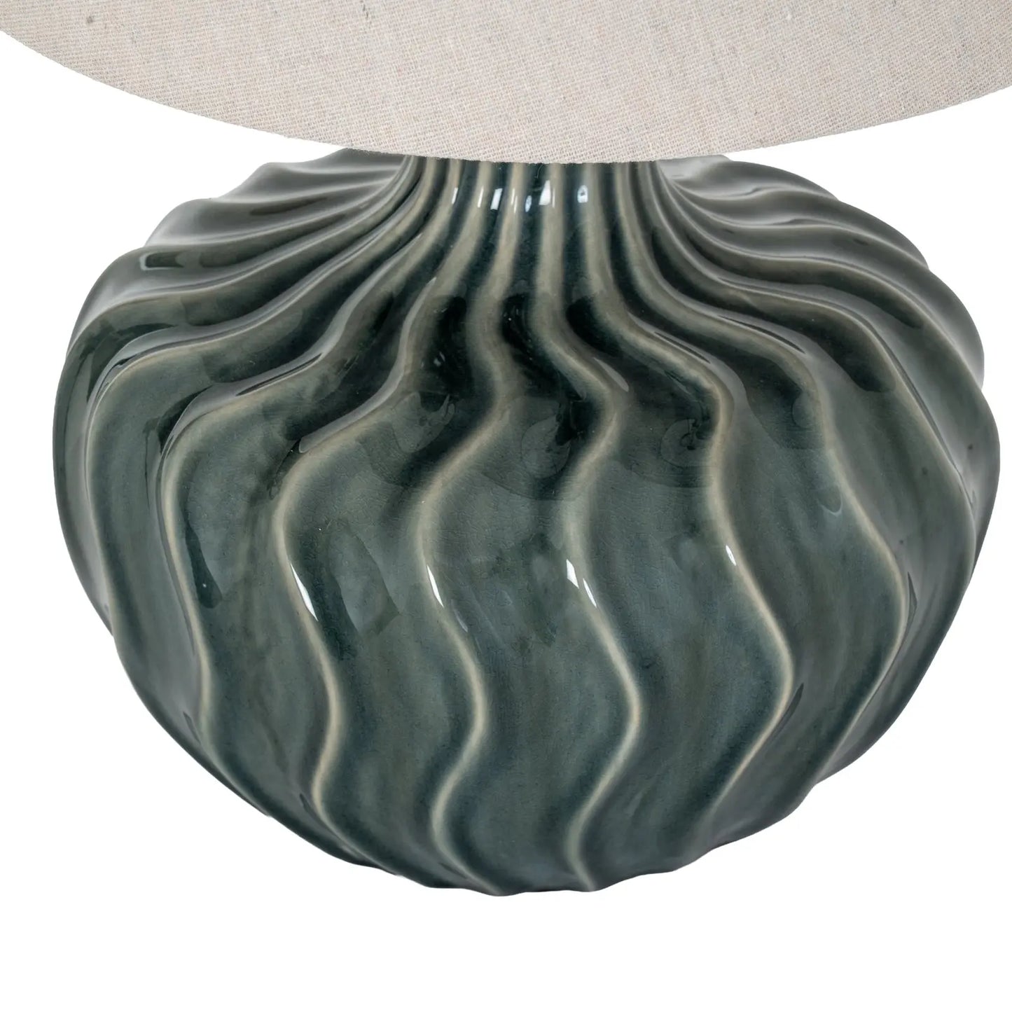 Decorative lamp base with wavy pattern on a white background