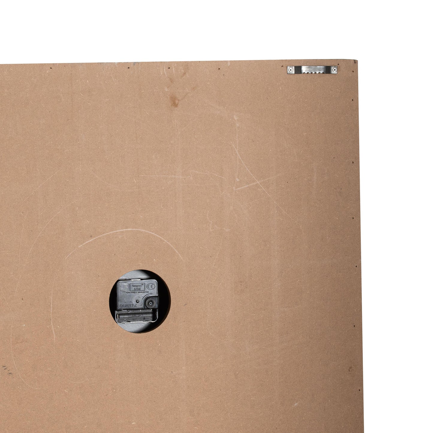 Brown cardboard box with a circular cutout revealing a camera inside.