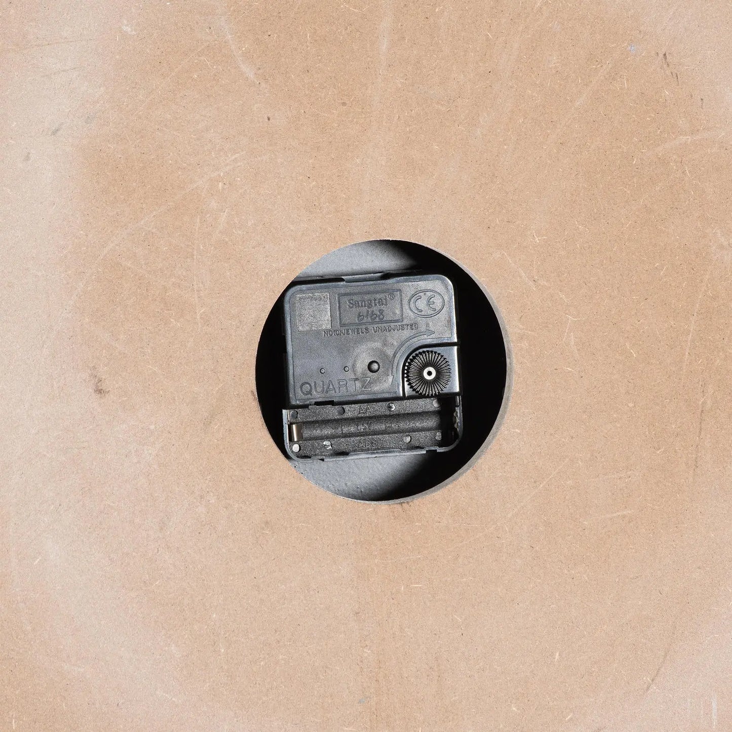 Small vintage camera on a textured beige background