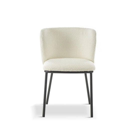 White upholstered chair with black legs on a white background