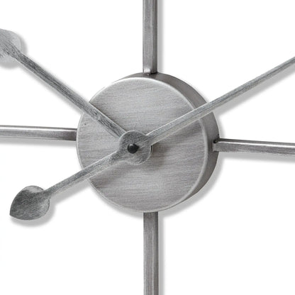 Close-up of a metallic wall clock with star-shaped design on a white background