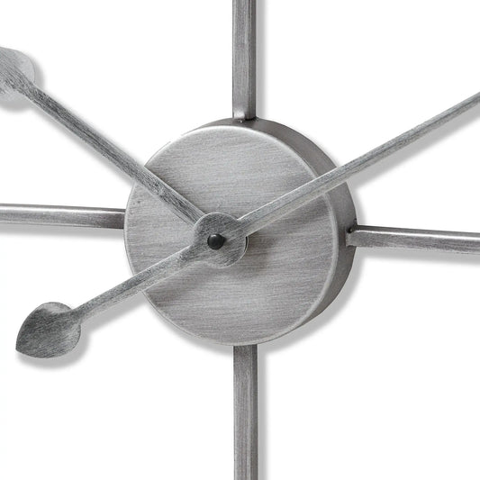 Close-up of a metallic wall clock with star-shaped design on a white background