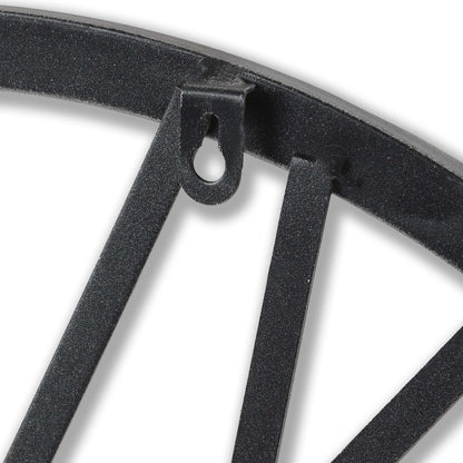 Close-up of a black metal decorative bracket on a white background