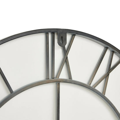 Close-up of a wall clock with metallic frame and white face