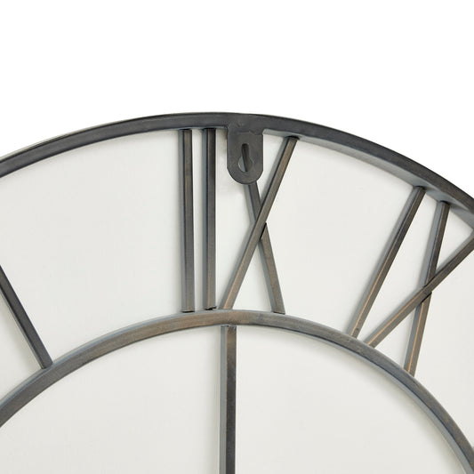 Close-up of a wall clock with metallic frame and white face