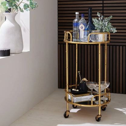 Gold bar cart with drinks and decor in a modern interior setting