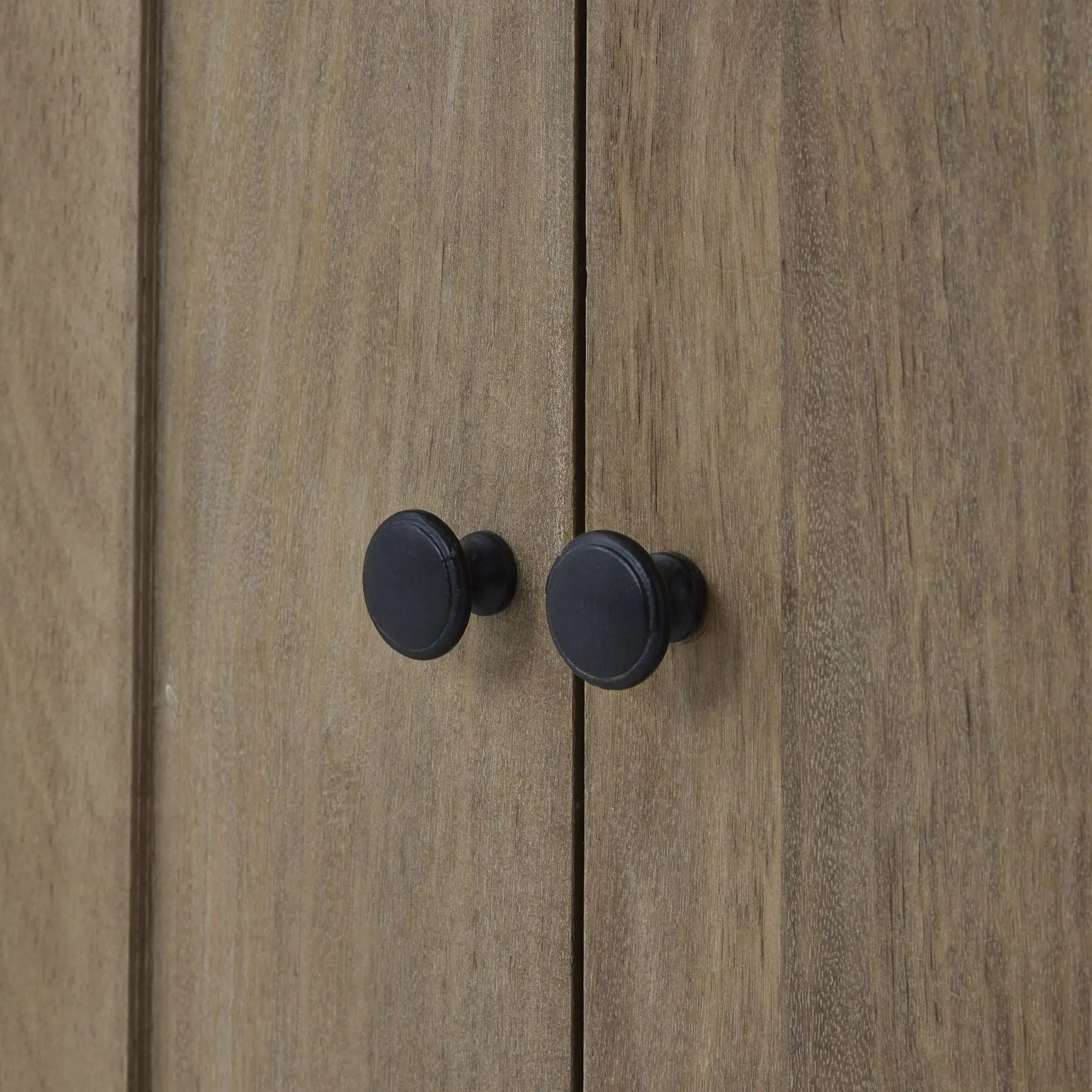 Wooden cabinet with black knobs