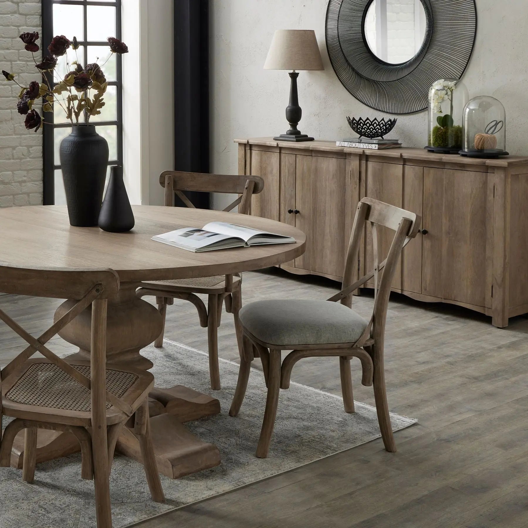 Dining room with wooden table and chairs, book, and decorative items.