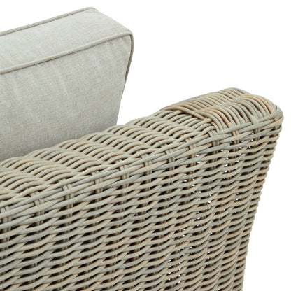 Close-up of a wicker chair with a beige cushion on a white background