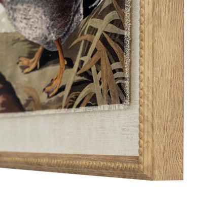 Close-up of a framed painting with a wooden frame and textured mat.