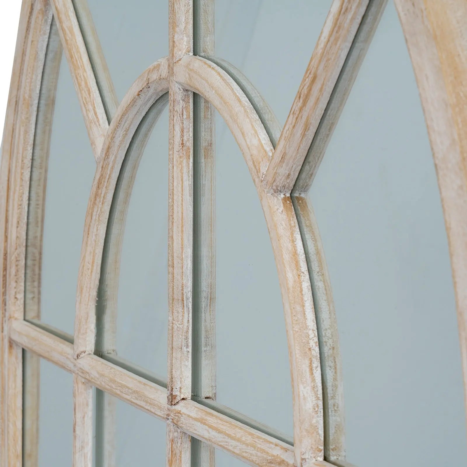 Wooden window frame with glass panes against a light blue background