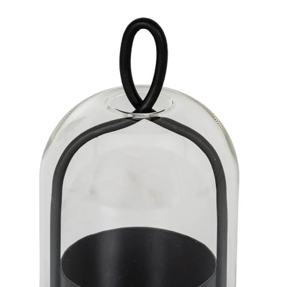 Clear glass cloche with black metal handle on a white background