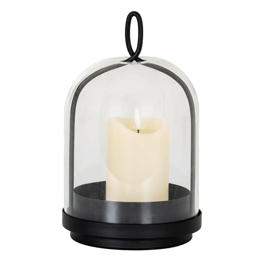 Candle in a glass dome with black base on a white background
