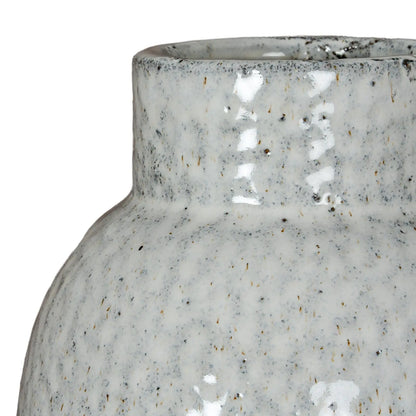 Close-up of a textured ceramic vase on a white background