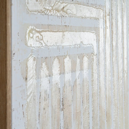 Abstract artwork with white and beige tones on a textured surface